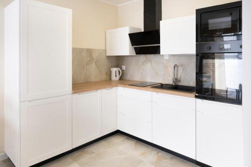Kuchyň nebo kuchyňský kout v ubytování Apartamenty Deluxe