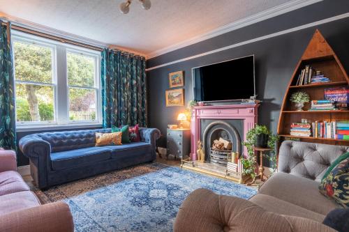 a living room with a couch and a fire place at Ness on the Lane in Inverness