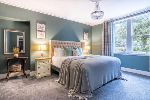a bedroom with a large bed and a window at Ness on the Lane in Inverness