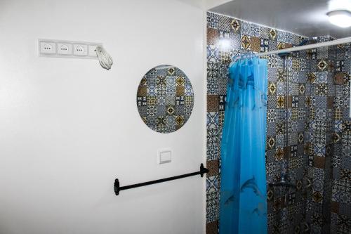 a bathroom with a shower with a blue curtain at CASA LUNA in the heart of old medina in Tangier