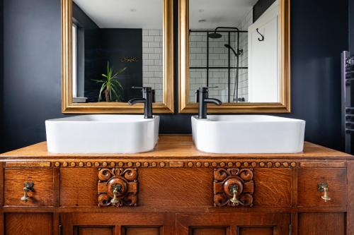 two sinks on top of a wooden vanity in a bathroom at Ness on the Lane in Inverness