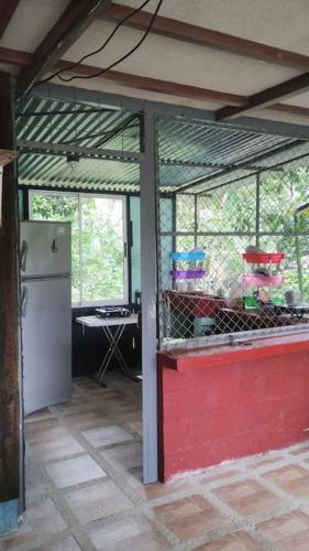 a kitchen with a red door and a refrigerator at viajero solitario in Buenos Aires