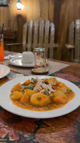 a white plate of food on a table at Natura Vista in Panglao