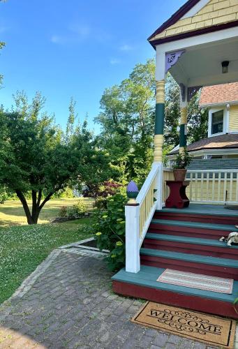 a front porch of a house with red stairs at Inn at the Oaks in Eastham