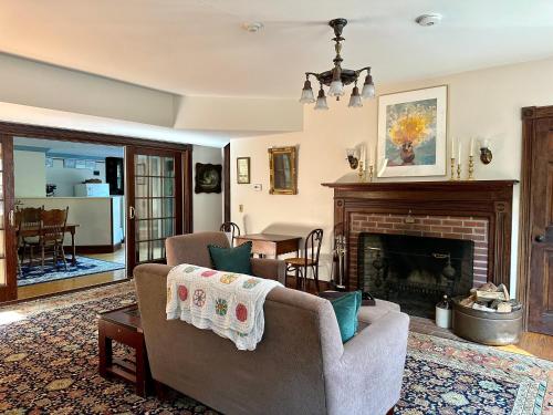 a living room with a couch and a fireplace at Inn at the Oaks in Eastham