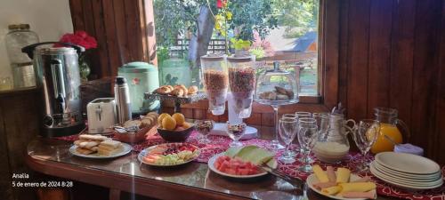 a table topped with plates and bowls of food at CASA del LAGO Bariloche in San Carlos de Bariloche