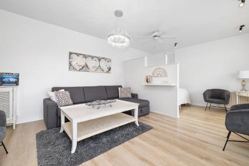 a living room with a couch and a table at River Apartments in Selfoss