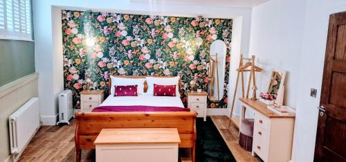 a bedroom with a bed with a floral wallpaper at Burton Stone Inn in York