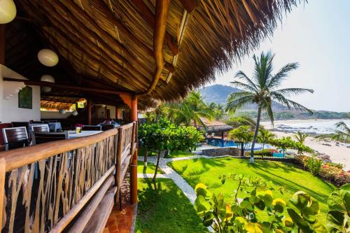 a balcony of a resort with a view of the ocean at Casa Manzanillo - Beach Room - Ocean Front Room at Exceptional Beach Front Location in Troncones