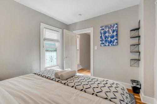 a white bedroom with a bed and a window at Downtown Getaway - Balcony - King Beds in Colorado Springs