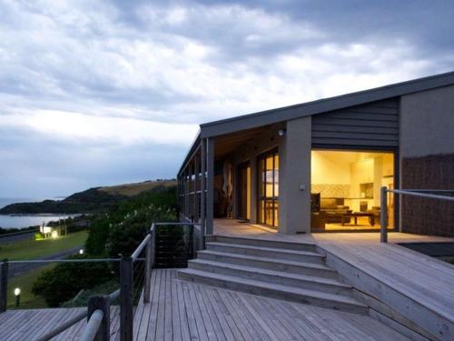 a house on a deck with a view of the water at 4 Whitecrest Great Ocean Road Resort - Ocean View in Wongarra
