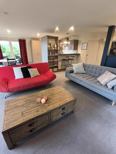 a living room with two couches and a coffee table at Vibrant Living Retreat in Hanmer Springs