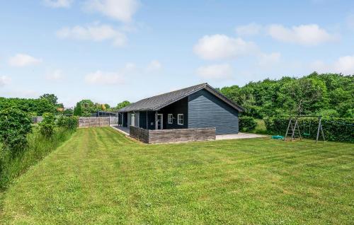 a house with a large yard in front of it at Holiday Home Kronens Have Tranekær I in Hou