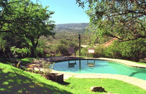 a swimming pool in the middle of a yard at Cabañas Del Rio in Mina Clavero
