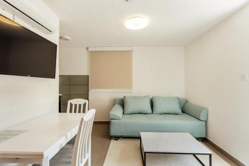 a living room with a couch and a table at All'oro in Njivice