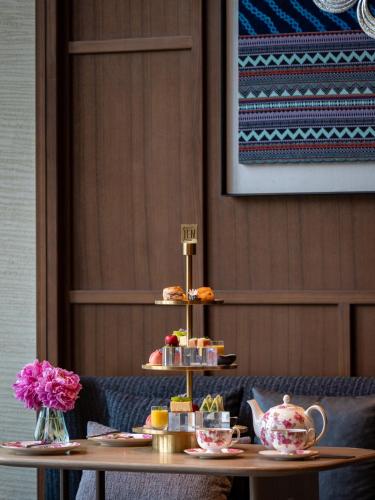 a table with two tiers of pastries and tea pots at JEN Kunming by Shangri-La in Kunming
