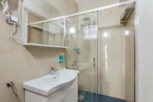 a bathroom with a sink and a shower at All'oro in Njivice