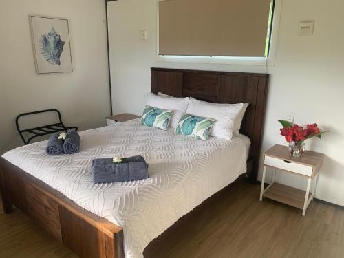 a bedroom with a large bed with two towels on it at Konini Retreat in Rarotonga