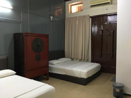 Postel nebo postele na pokoji v ubytování Old Penang Hotel - Trang Road