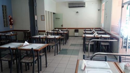 an empty dining room with tables and chairs at Hotel Plaza Roma in Buenos Aires