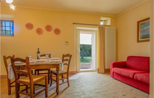 a living room with a table and a red couch at Beautiful Apartment In Lamporecchio in Lamporecchio
