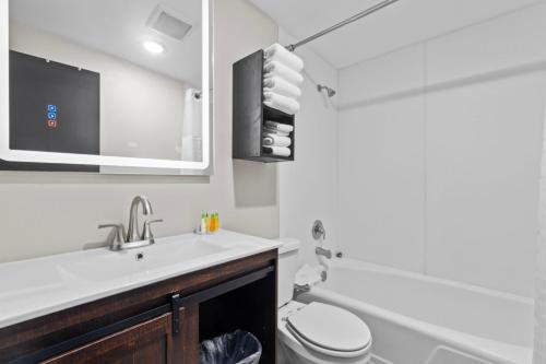 a bathroom with a sink and a toilet and a mirror at Lost Trail in Lava Hot Springs