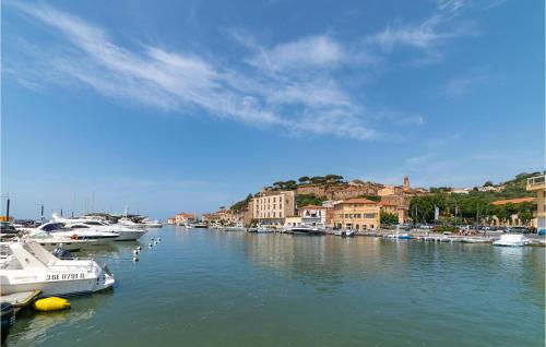 a group of boats docked in a river with buildings at Apt A21 in Grosseto