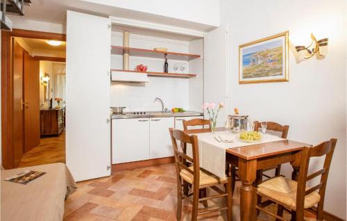 a kitchen and dining room with a table and chairs at Apt A21 in Grosseto