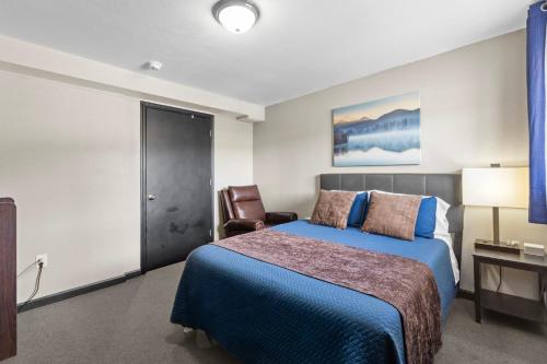 a hotel room with a bed and a chair at Lost Trail in Lava Hot Springs