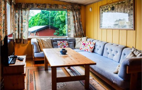 a living room with a couch and a table at Amazing Home In Saltnes With Wifi in Saltnes