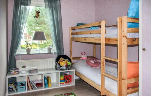a bedroom with two bunk beds and a window at Amazing Home In Båstad With Wifi in Båstad