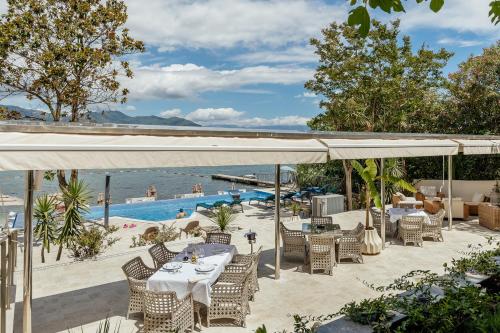 a patio with a table and chairs and a pool at All'oro in Njivice