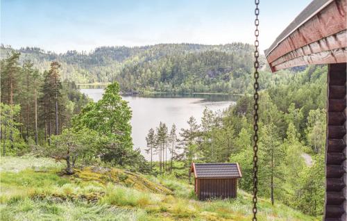 a view of a lake from a swing at 5 Bedroom Gorgeous Home In Vegårshei in Vegårshei