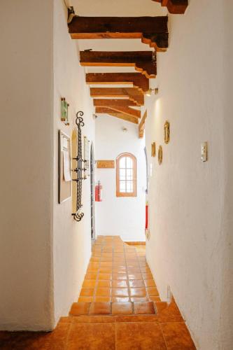 an empty hallway with a tile floor and wooden ceilings at Casa Aimée in Mexico City