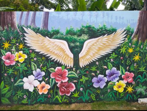 a painting of an eagle flying over flowers at Hotel villa J Leticia in Cereté