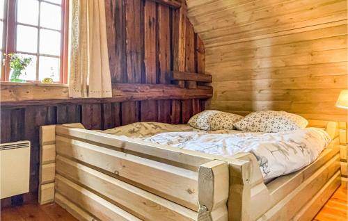 a bedroom with a bed in a log cabin at 3 Bedroom Awesome Home In Årjäng in Årjäng