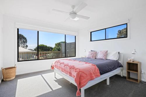 a bedroom with a bed and a large window at Sommerhuset by Ready Set Stay in Cowes