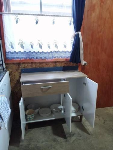 a small bathroom with a sink and a window at Cabaña Choroy dentro del pueblo, cercano a playas in Licán Ray