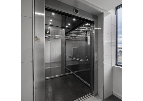 a shower in a bathroom with a glass door at CBD Apartments by the International in Wagga Wagga