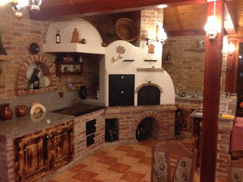 a large kitchen with a brick wall and an oven at Vándor Vigadó in Zalaegerszeg