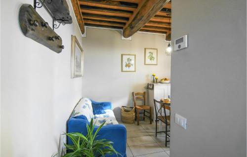 a living room with a blue couch and a table at Awesome Home In Macchino With Kitchen in Marliana