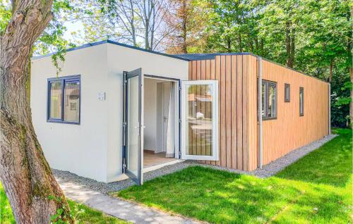 a small house with an open door in a yard at 3 Bedroom Cozy Home In Heinkenszand in Heinkensand