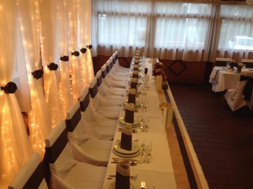 a long table in a banquet hall with lights at Vándor Vigadó in Zalaegerszeg