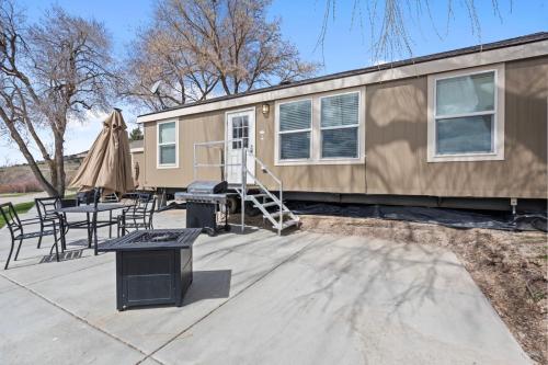 a tiny house with a patio and a table and chairs at Lost Trail in Lava Hot Springs