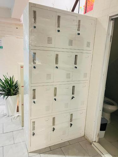 a large white chest of drawers in a bathroom at Before We Go Hostel Donmueang in Ban Ko