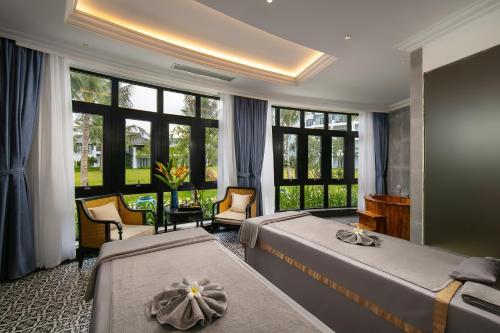 Postel nebo postele na pokoji v ubytování Bliss Hoi An Beach Resort & Wellness