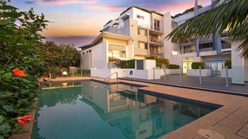 a swimming pool in front of a building at Ettalong Beach - Poolside Luxury in Ettalong Beach