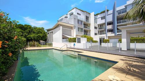 a swimming pool in front of a building at Ettalong Beach - Poolside Luxury in Ettalong Beach
