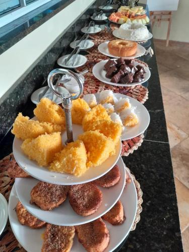 a row of plates of pastries on a counter at Pousada Vila do Mar in São Luís
