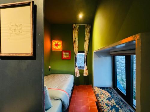 a small room with a bed and a window at Âm Ấm Đà Lạt Boutique Hotel & Cozy Bistro in Khu Chi Lăng